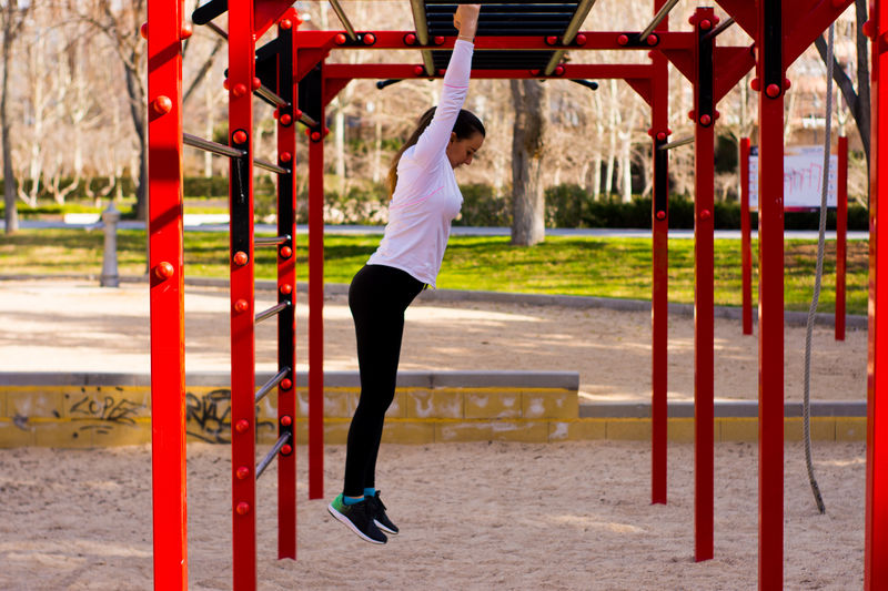 Side view of woman exercising at park