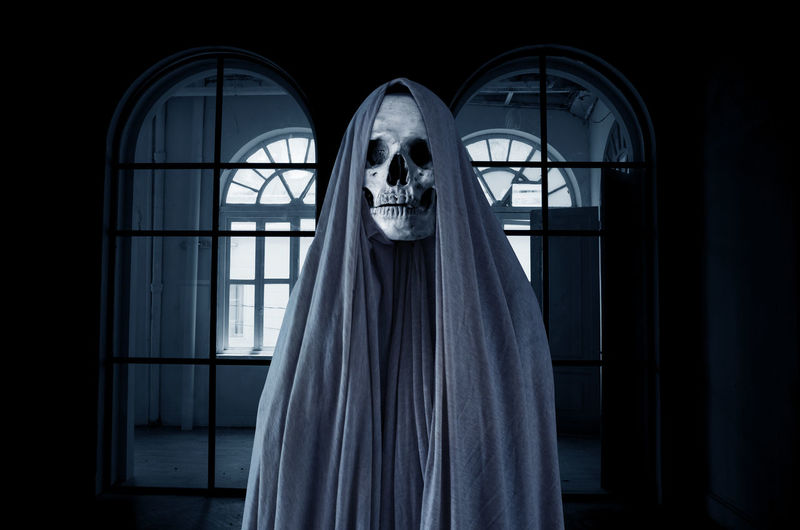 Spooky skull in empty dark room