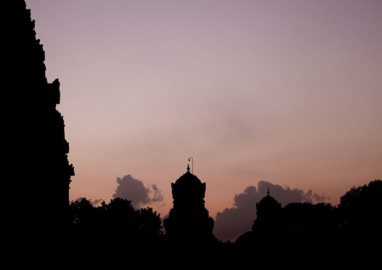Silhouette built structures at sunset