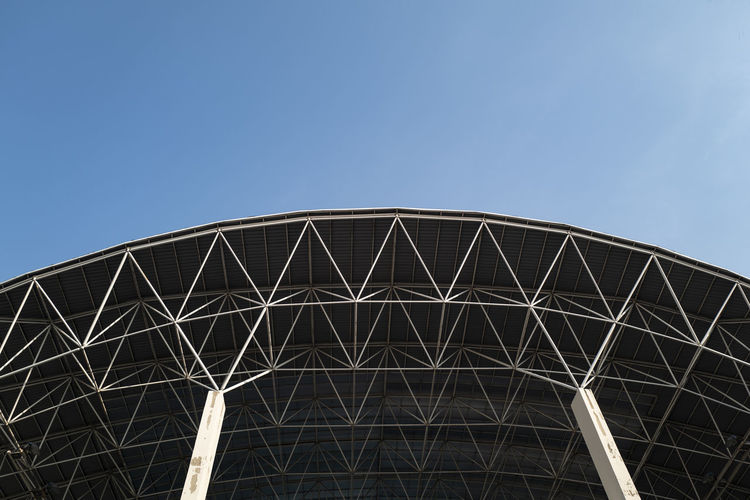 Low angle view of metallic structure against blue sky