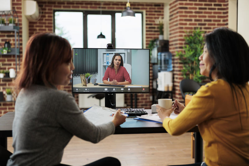 Businesswomen talking on video conference at office