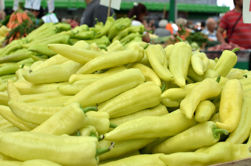 Pile of green peppers on a green market stall