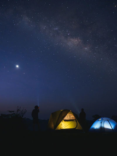 Tourists tents on mountain under the milky way