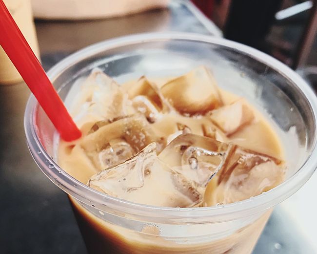 Close-up of iced coffee in glass on table