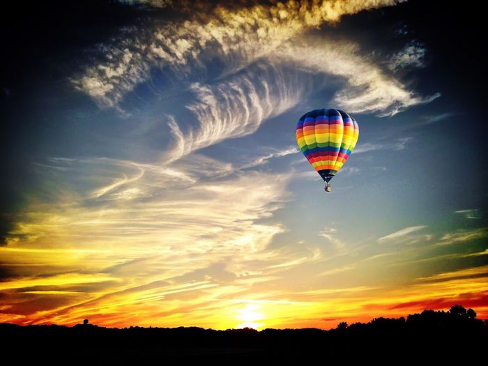 Low angle view of hot air balloon flying over landscape