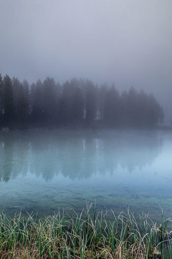 Scenic view of lake against sky during winter