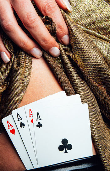 Cropped image of woman showing playing cards