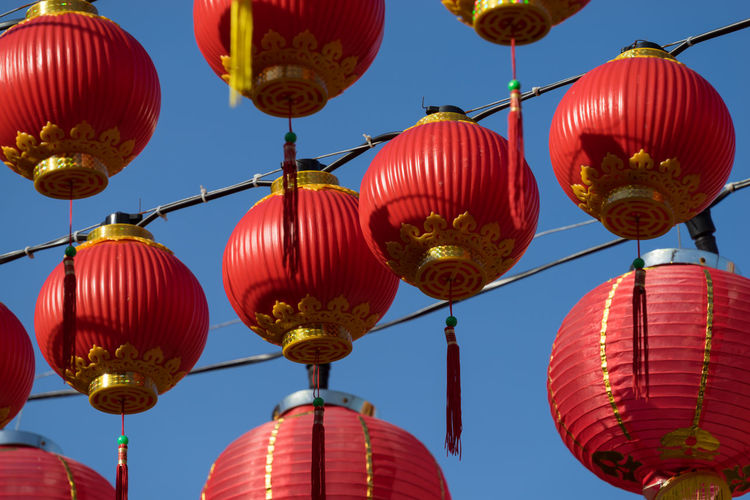 Low angle view of chinese lanterns hanging against sky
