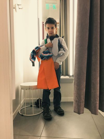 Boy standing in fitting room
