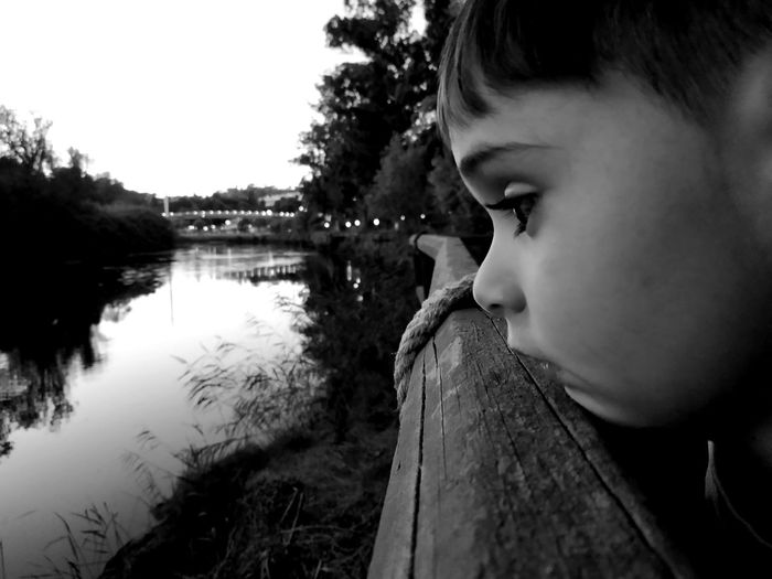 Cute boy looking at lake