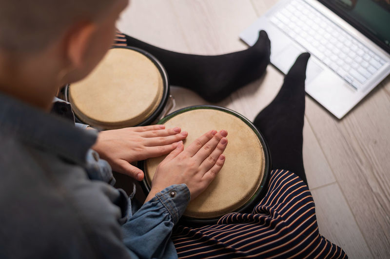 High angle view of woman playing drum