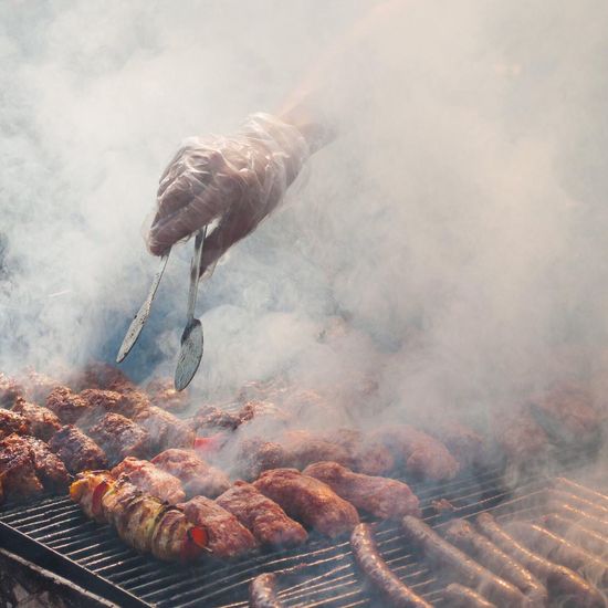 Smoke emitting from meat on barbecue grill
