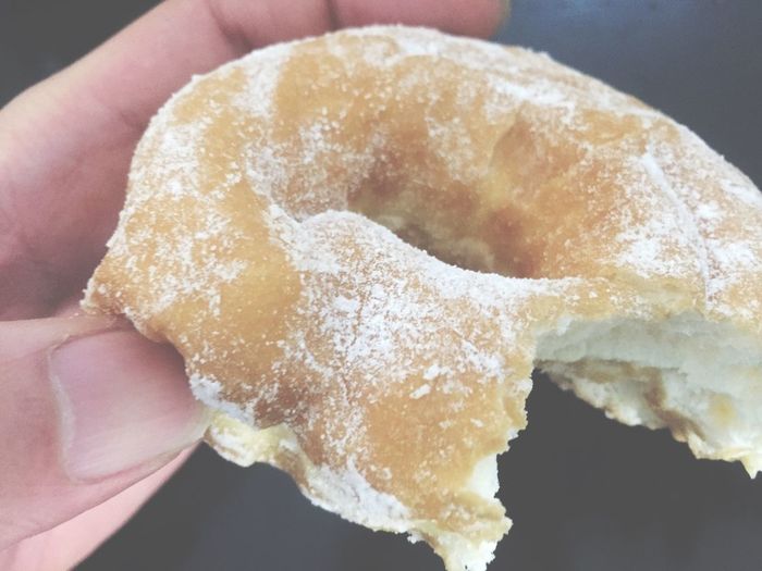 Cropped imaged of person holding donut