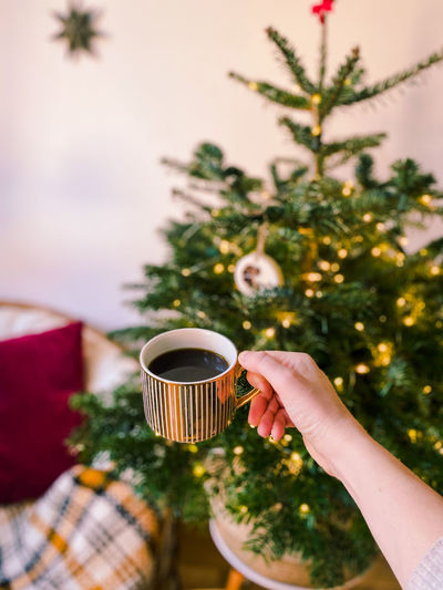 Cropped image of hand holding coffee cup
