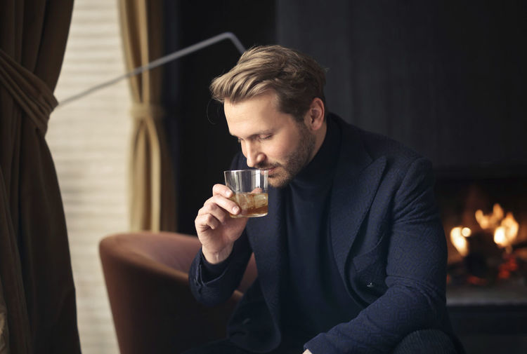 Handsome man drinks a whisky