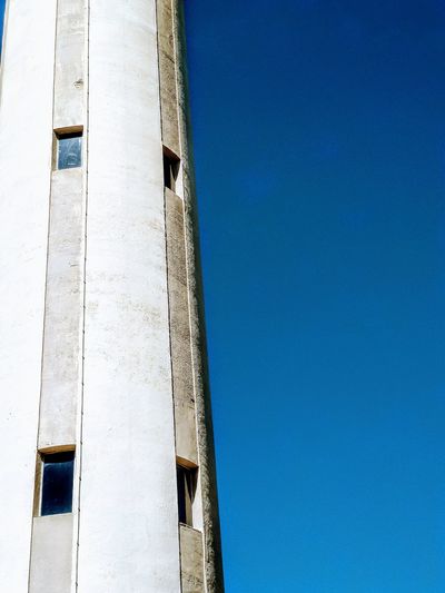 Low angle view of old building against clear blue sky