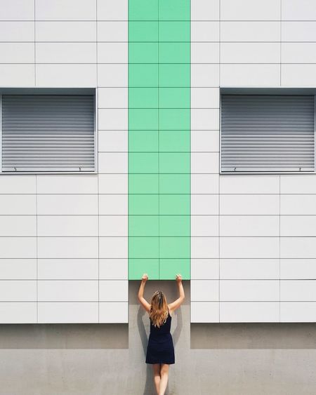 Woman standing against building