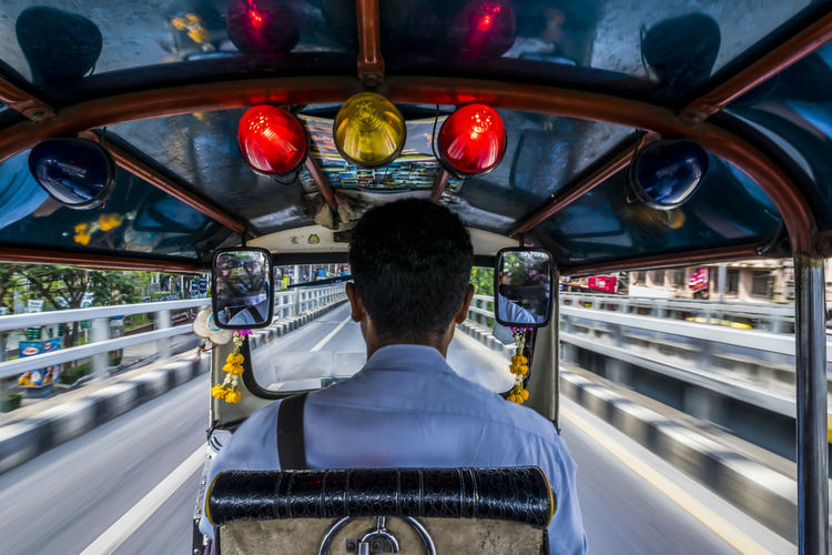 Rear view of man driving jinrikisha