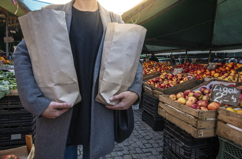 Midsection of man standing at market stall