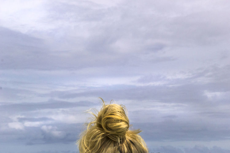 Rear view of woman looking against sky