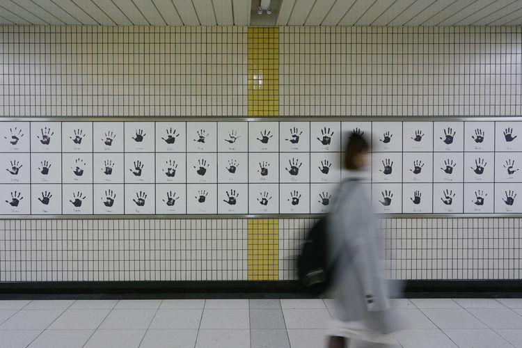 Blurred motion of man walking on subway station