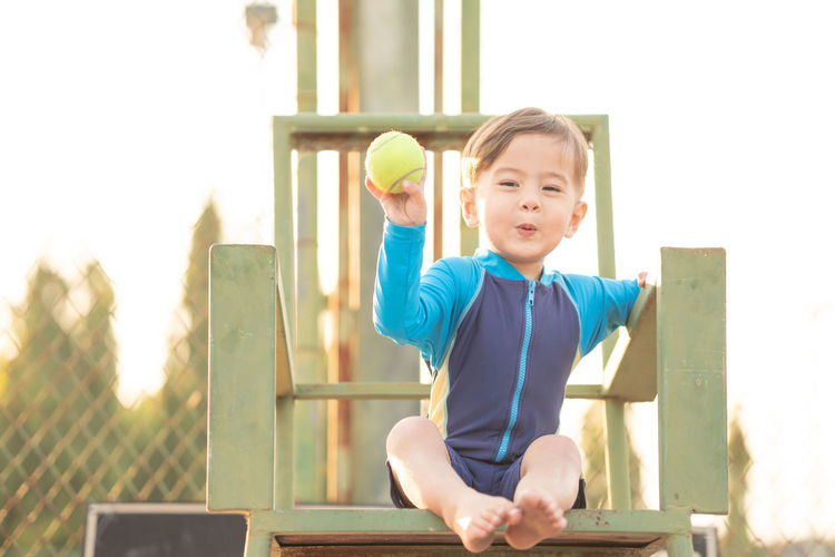 Portrait of cute boy playing with ball
