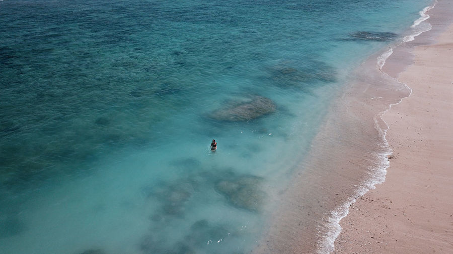 Aerial view of woman standing on beach