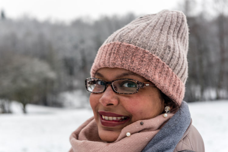 Close-up portrait of smiling woman during winter