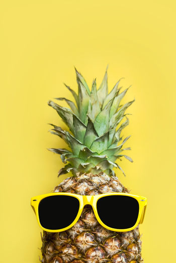 Close-up of pineapple against yellow background