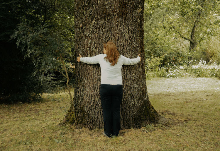 Rear view of woman standing on field