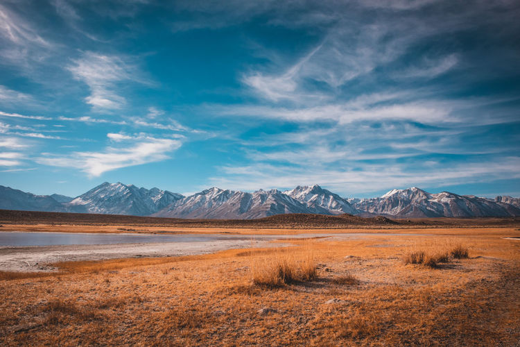 Scenic view of desert against blue sky