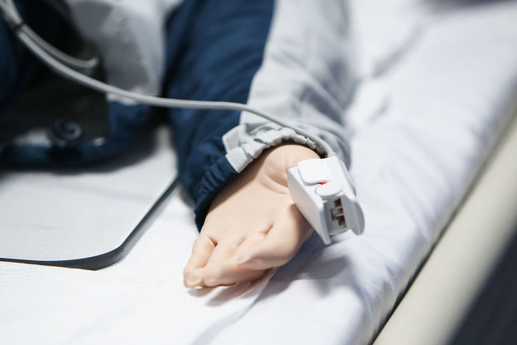 Low section of person lying on bed
