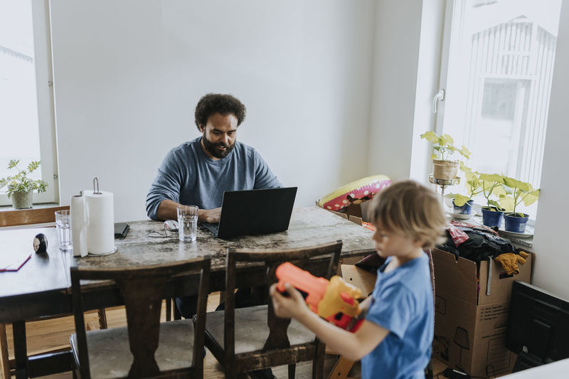 Man working from home and taking care of child