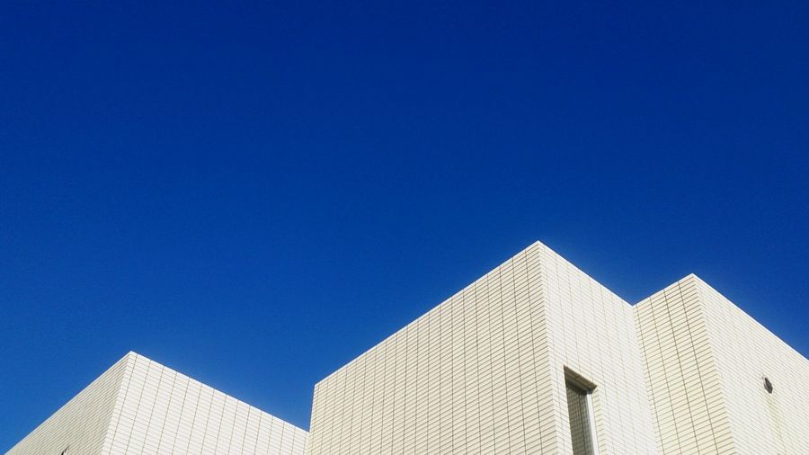 High section of building against clear blue sky