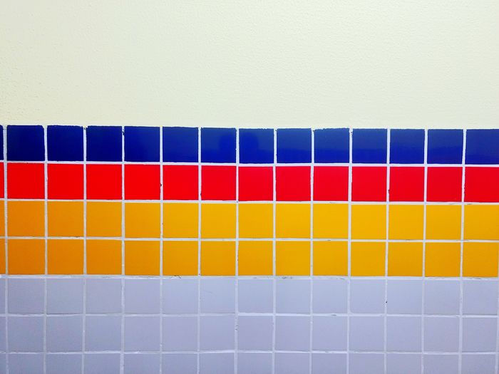 Close-up of multi colored tiles on wall