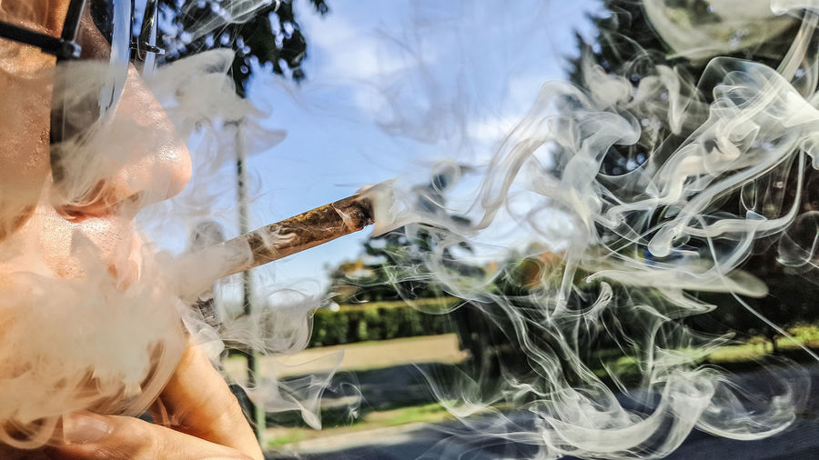 Close-up of man smoking marijuana joint