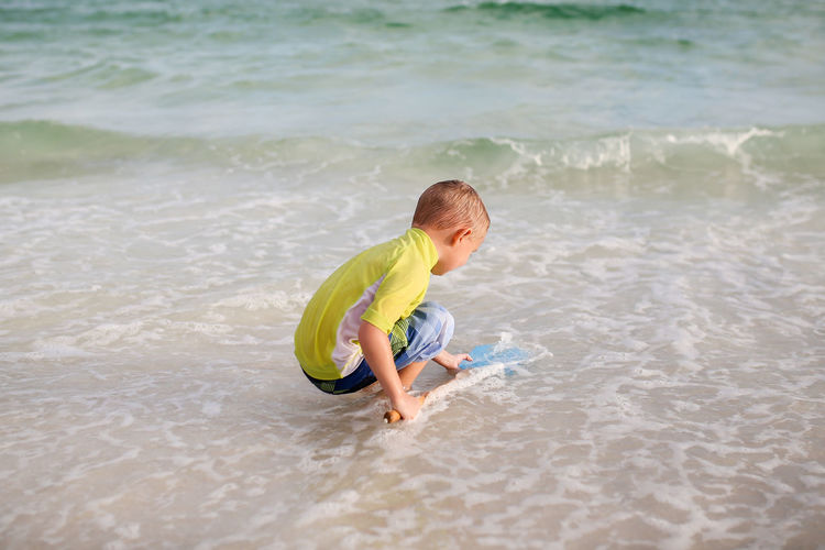 Boy playing in water at beach