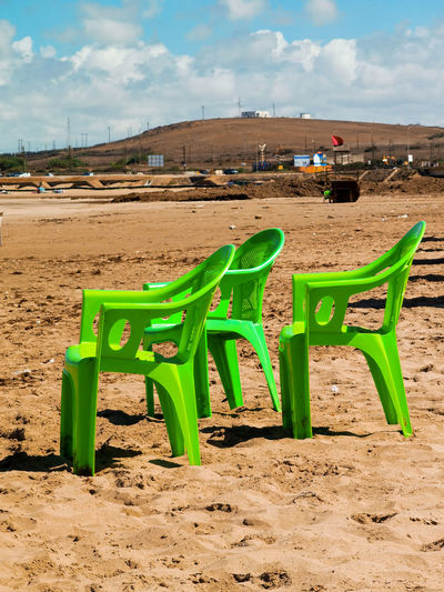 Green chairs on the beach