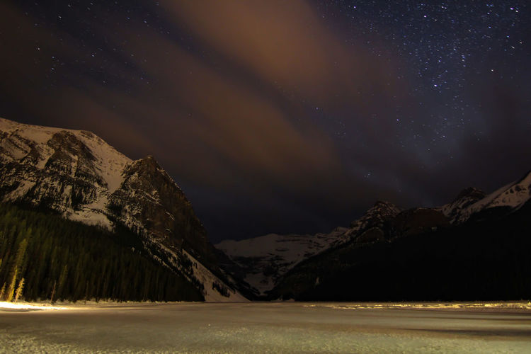 Scenic view of lake louise against sky at night