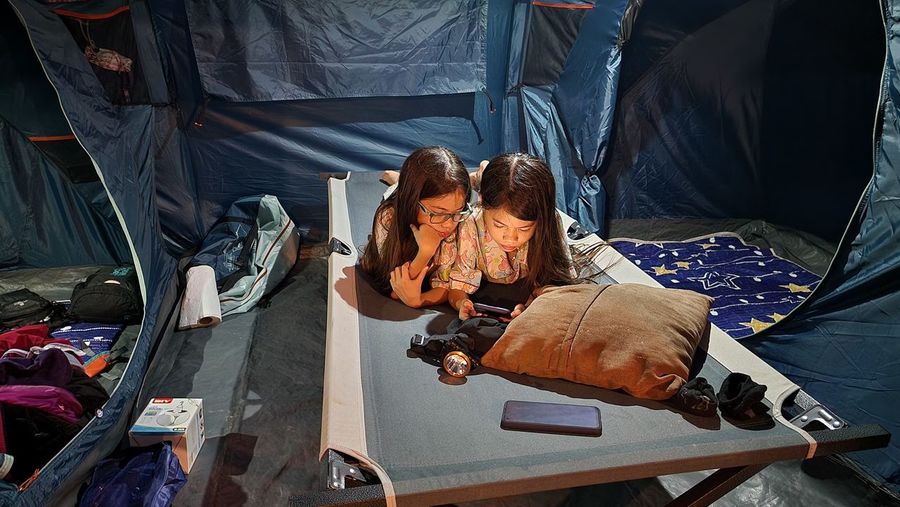High angle view of woman sitting in tent