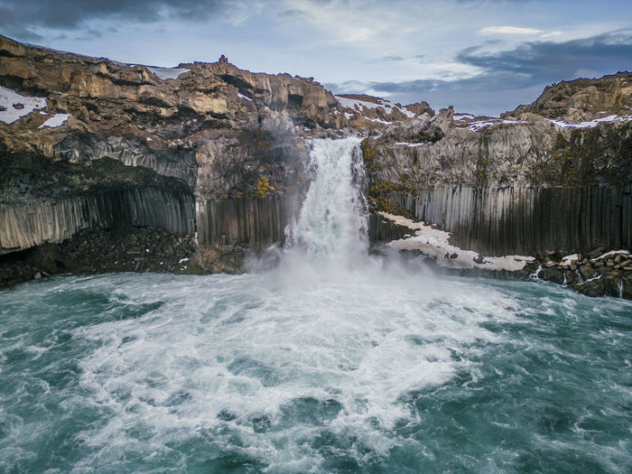 A wide shot low angle drone view of aldeyjarfoss waterfall in north iceland 