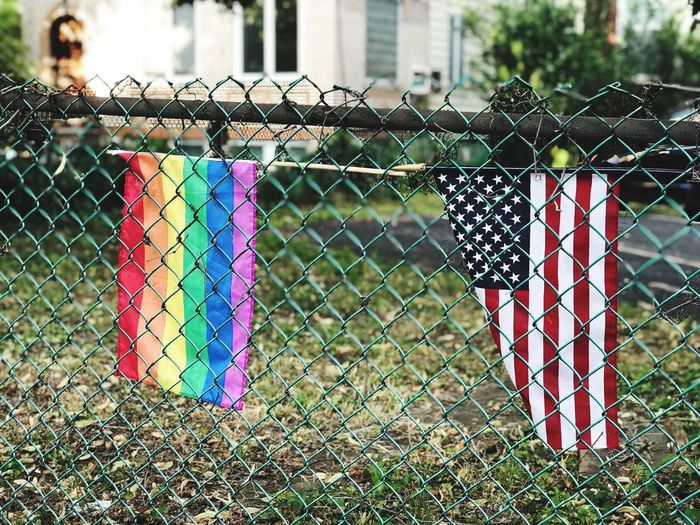 Close-up of multi colored fence against building