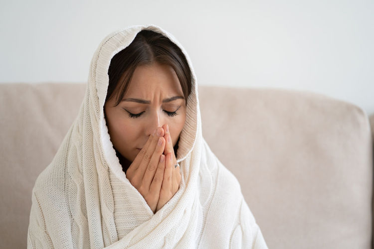 Close-up of depressed woman praying at home