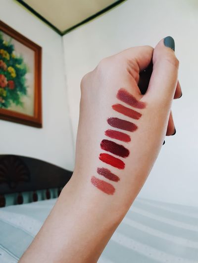 Close-up of lipstick shades on hand at home