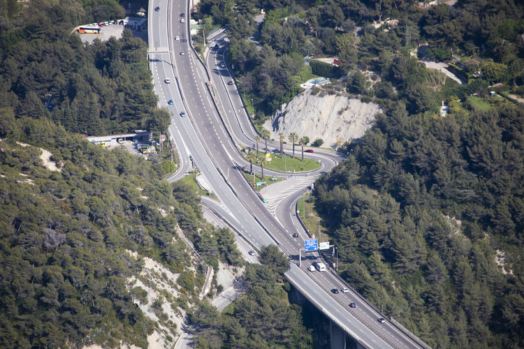 High angle view of highway amidst trees in city