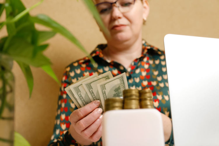 Caucasian woman girl hand counting cash money for pay loan. save money for future and retirement.
