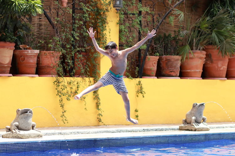 Full length of man jumping in swimming pool