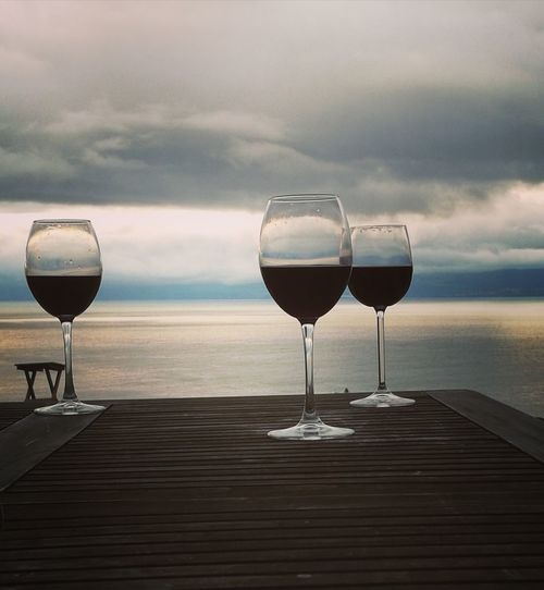 Wineglass on jetty by sea
