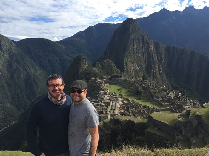 Portrait of smiling friends standing at machu picchu