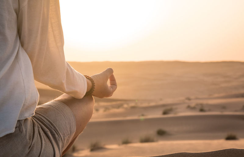 Close-up of woman meditating in desert
